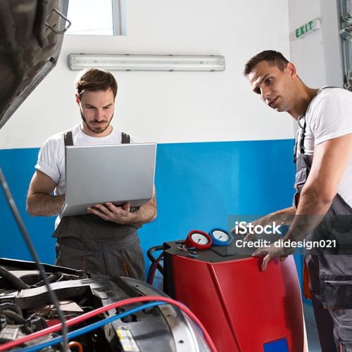 Mechanic work together in automobile shop, repair climate on car